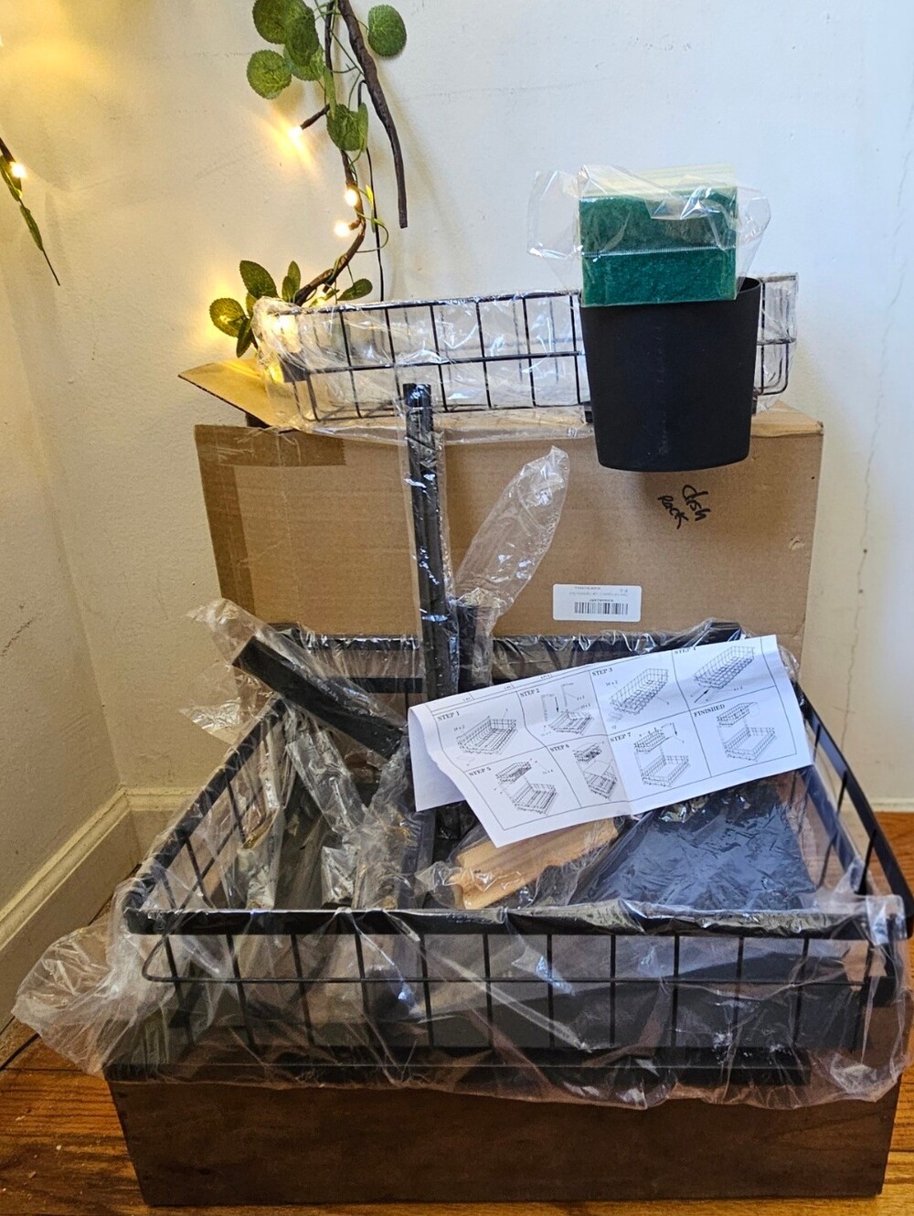 Black nib metal two-tier wire basket organizer. A smaller wire basket stacked se